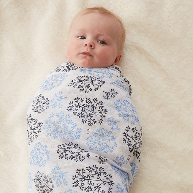 Stretch Muslin Wrap by Little Turtle Baby Color White with Blue Leaves